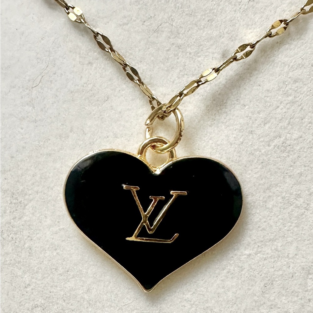 Louis Vuitton black/gold heart charm/zipper pull. Authentic. LV Stamp on back..